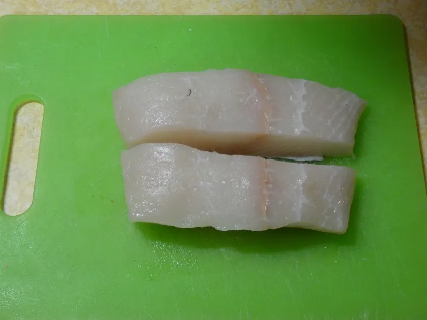 Seared halibut with saffron cream sauce close-up